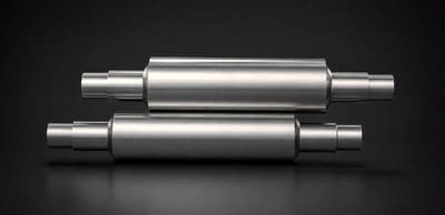 Two EN-grade forged steel rolls on a dark background