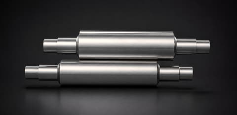 Two EN-grade forged steel rolls on a dark background