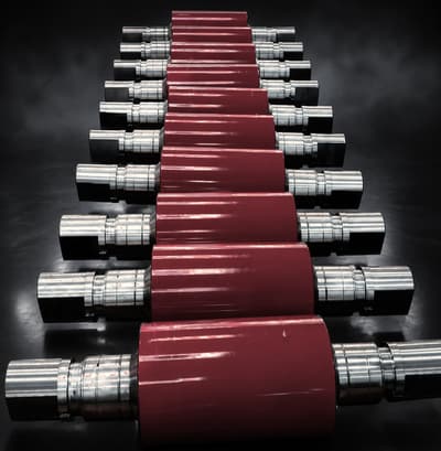 Row of chilled cast iron rolls with red-painted barrels
